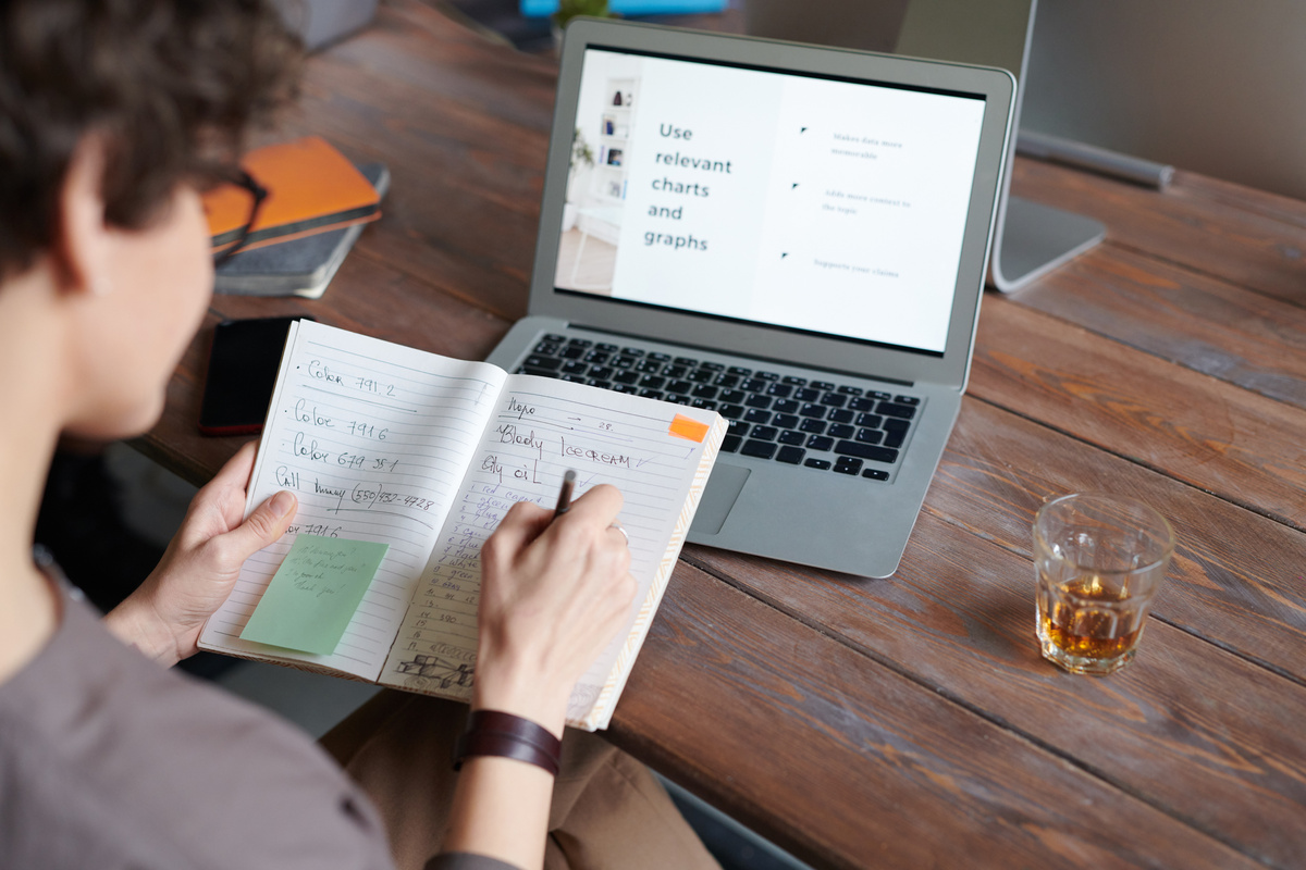 Woman writing on a diary in the office